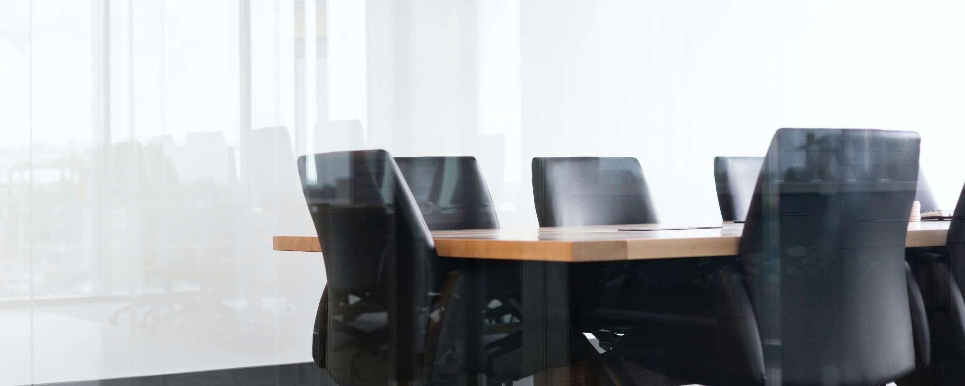 Empty chairs around a conference table